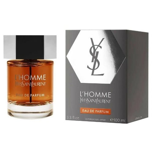 Elegant Yves Saint Laurent L’Homme Eau de Parfum 100ml, housed in a minimalist clear flacon with smooth edges, subtle amber liquid, and metallic silver spray top, reflecting contemporary masculinity, confidence, and refined charm.
