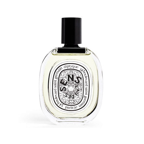 Eau des Sens Eau de Toilette by Diptyque, 100ml fragrance combining orange blossom, juniper berries, and patchouli, housed in a clear oval bottle with black detailing.