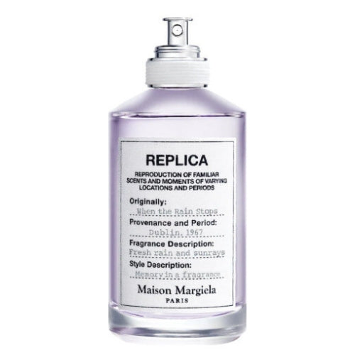Maison Margiela Replica When The Rain Stops Eau de Toilette bottle beside its box featuring a rain-inspired nature photograph.