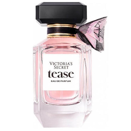 Victoria’s Secret Tease Eau de Parfum 100ml, designed in a soft pink faceted glass flacon with geometric facets, black bow accent, and matching spray cap, exuding playful sophistication, charm, and modern elegance.